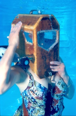 Bauer, diving underwater in a wooden Griswood helmet.